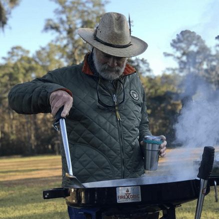 man cooking on a firedisc